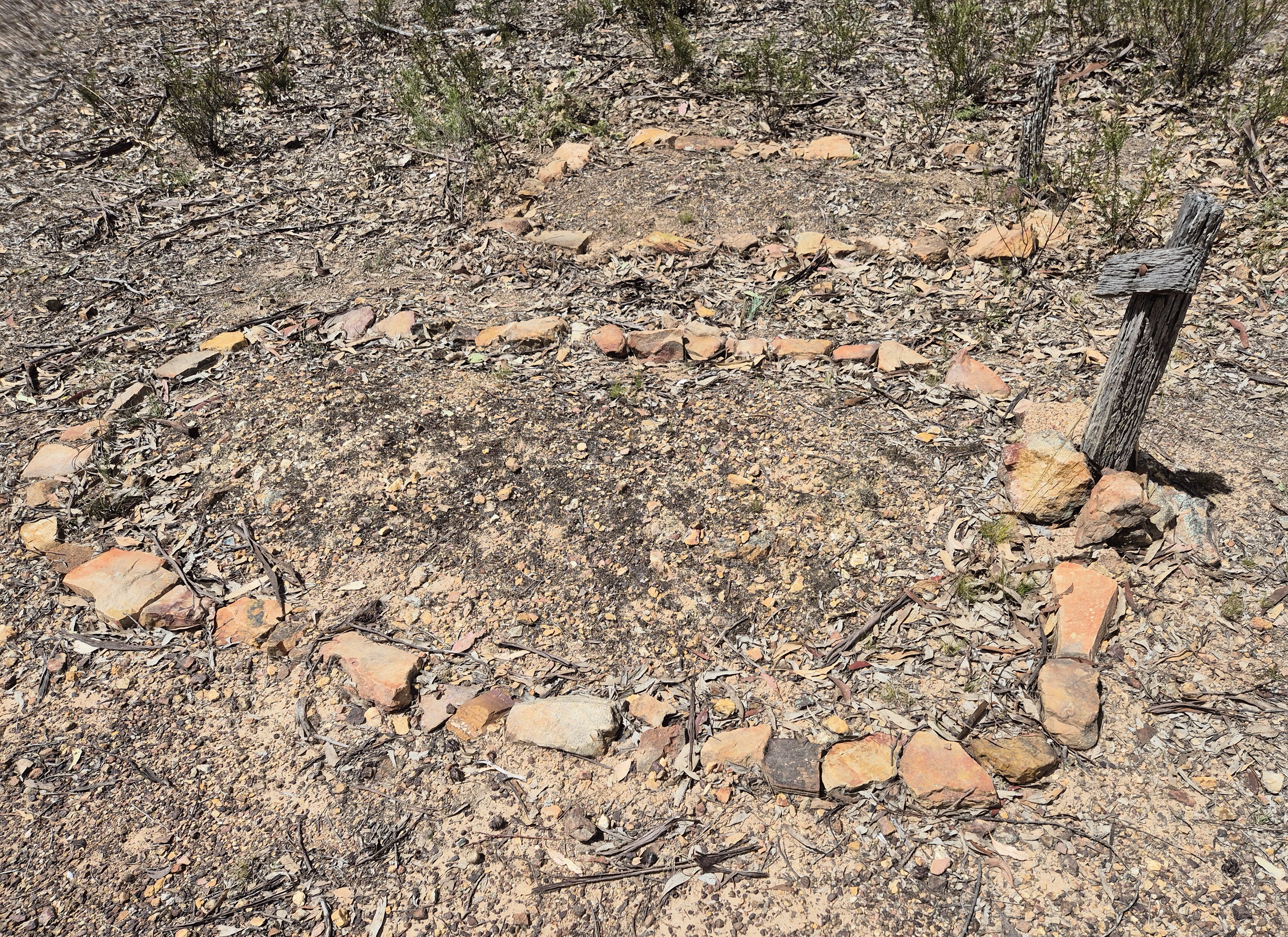 Grave mound reinforced by stone surround, 2025
